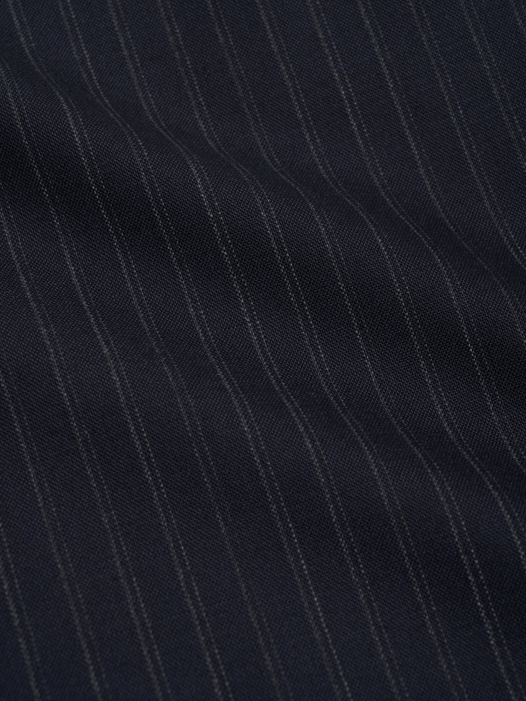 Orsman wide-leg navy pinstripe wool trousers worn on model, fabric close up view