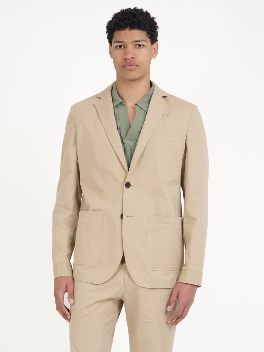 Detailed shot of model wearing Oliver Spencer Men's Unstructured Notch Lapel Beige Cotton Jacket
